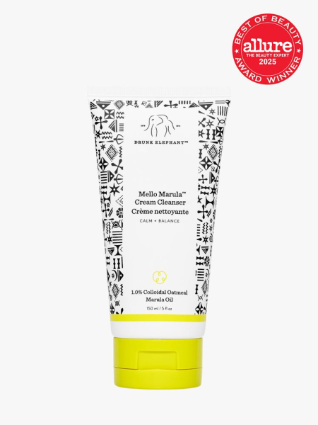 Drunk Elephant Mello Marula Cream Cleanser white bottle with black pattern design and yellow cap on light gray background with red Allure Best of Beauty seal in the top right corner